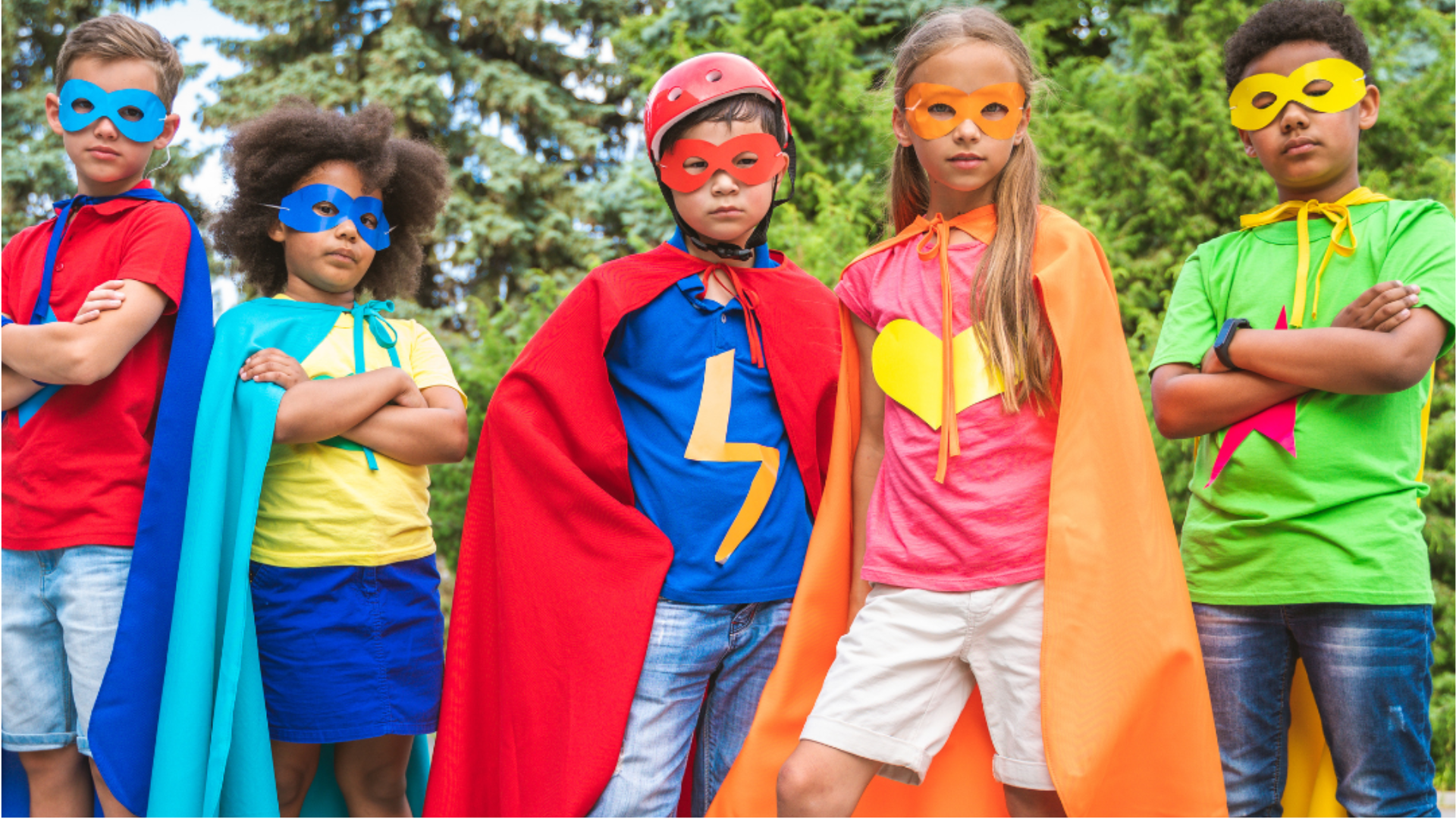 A group of children dressed in bright superhero costumes