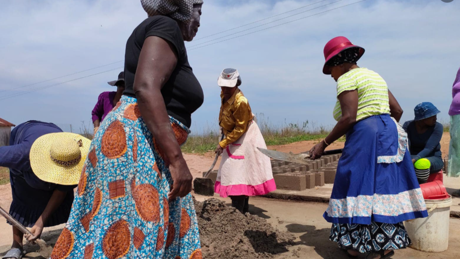 Ladies filling moulds with cement