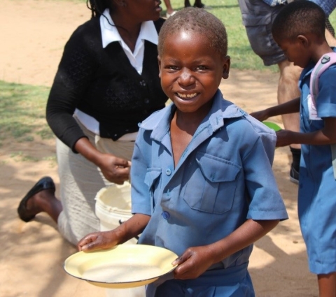 Boy smiling with breakfast