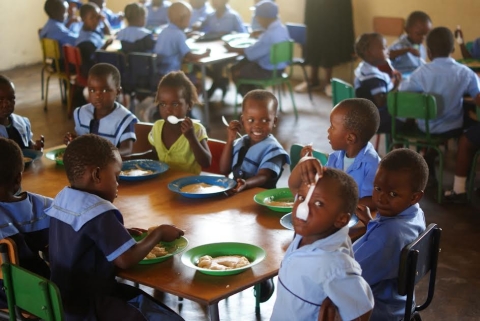 Children at ECE school eating porridge