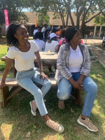 Two women sitting on a bench 