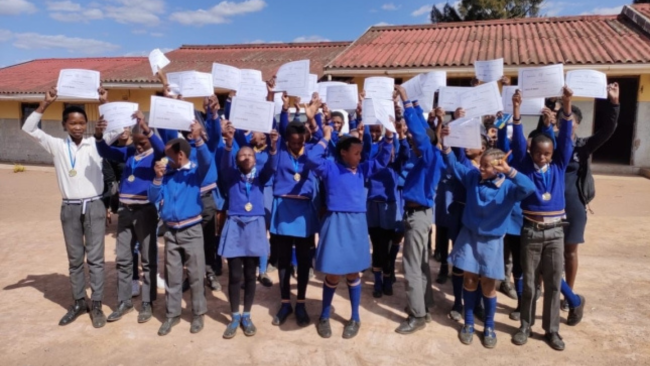 A group of children from the Beaded Anklet Project