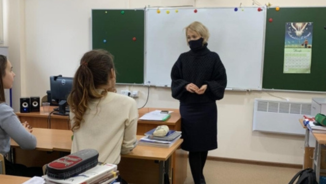 Educator at front of classroom