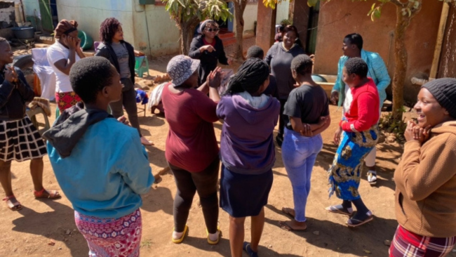 Ladies in the community being told about Shining Star