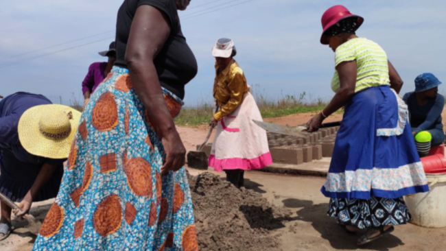 Ladies making blocks for building houses